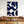 Large hand-painted abstract oil painting with minimalist organic fluid shapes in deep indigo blue and warm cream, displayed above a low wooden table in a relaxing boho style living room.