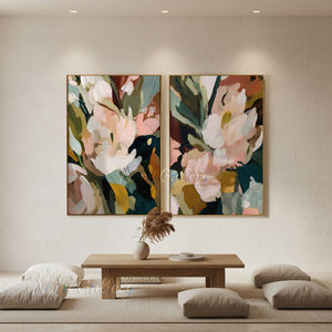 100% handmade modern abstract floral oil painting featuring a diptych design of blooming flowers in pink, green, and neutral earth tones, displayed in a stylish living room setting above a gray sofa.