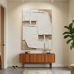 Original handmade heavy textured abstract oil painting in minimalist white and warm beige earthy tones, styled on a neutral plaster wall in a low-seating modern Boho living room.