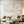 A 100% hand-painted minimalist wabi-sabi oil painting showcasing thick 3D textured plaster white and ivory blocks on a warm neutral background with a vertical ribbed engraved detail.
