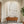 Large original handmade 3D heavy textured minimalist oil painting in plaster white and natural earthy beige tones, styled on a warm beige plaster wall in an upscale Japandi living room above a low wooden table with floor cushions.