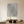 Large hand-painted 3D textured beige abstract oil painting with two teardrop-shaped concentric swirls, displayed in a serene minimalist living room with Zen-style decor.