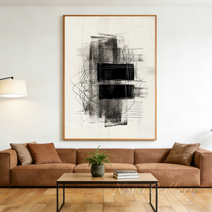 Hand-painted abstract oil painting with two heavy textured black rectangular blocks overlaid with thin intersecting lines, framed in black and styled in a bright, high-ceiling modern home interior next to a minimalist concrete staircase.