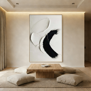Close-up of a hand-painted 3D textured oil painting featuring a bold black swoosh and white impasto strokes on a minimalist canvas, styled in a modern Wabi-Sabi living room.