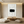 A hand-painted 3D textured oil painting featuring a central black rectangular block on a white impasto background, displayed in a serene modern Wabi-Sabi styled room.