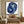 Hand-painted abstract oil painting with heavy texture impasto brushstrokes forming a blue and purple circular swirl vortex on a clean white background.