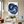 Large handmade abstract oil painting showcasing thick textured brushstrokes of a continuous loop swirl in navy and cobalt blue, framed in gold and hung on a minimalist beige living room wall above a modern white sofa.