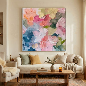Hand-painted heavy texture abstract oil painting showing a colorful, dense cluster of blooming flowers in shades of peach pink, coral, yellow, and peacock blue with vertical paint drips.