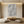 Close-up of a hand-painted 3D oil painting with raised S-curve geometric patterns in white, creating a rhythmic relief texture, shown in a modern minimalist living room setting.