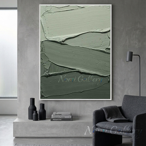 Large handmade minimalist abstract canvas painting featuring a soft sage green organic block and a sweeping, continuous fluid black curve on an ivory background, framed in black and hung on a modern warm-grey living room wall above a contemporary sofa.