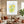 Minimalist handmade oil painting with a soft watercolor effect featuring a branch of ripe yellow lemons, sliced green limes, and light blue and yellow floating bubbles on a white background.