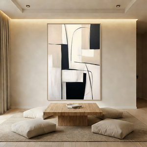 A hand-painted minimalist oil painting showcasing an asymmetrical composition of black and beige geometric blocks intersected by delicate black curved lines, displayed in a bright, modern living room.