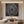 Hand-painted minimalist abstract oil painting featuring beige concentric lines looping outward like a geometric rose over a heavily textured, dark charcoal black brushstroke background.