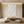 A hand-painted 3D white oil painting with layered horizontal and vertical geometric textures, creating a sculptural relief effect, styled in a minimalist sunlit living room.